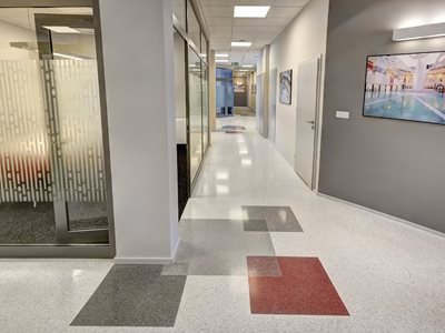 Detail of office corridor featuring resin flooring