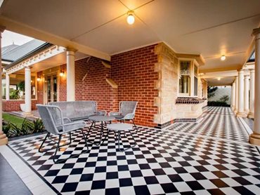 The black and white checkerboard tessellated design complements the American Tudor home 