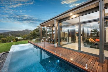 Full height glazing at the front of the home provides each room with views, and access to the expansive deck and the infinity lap pool