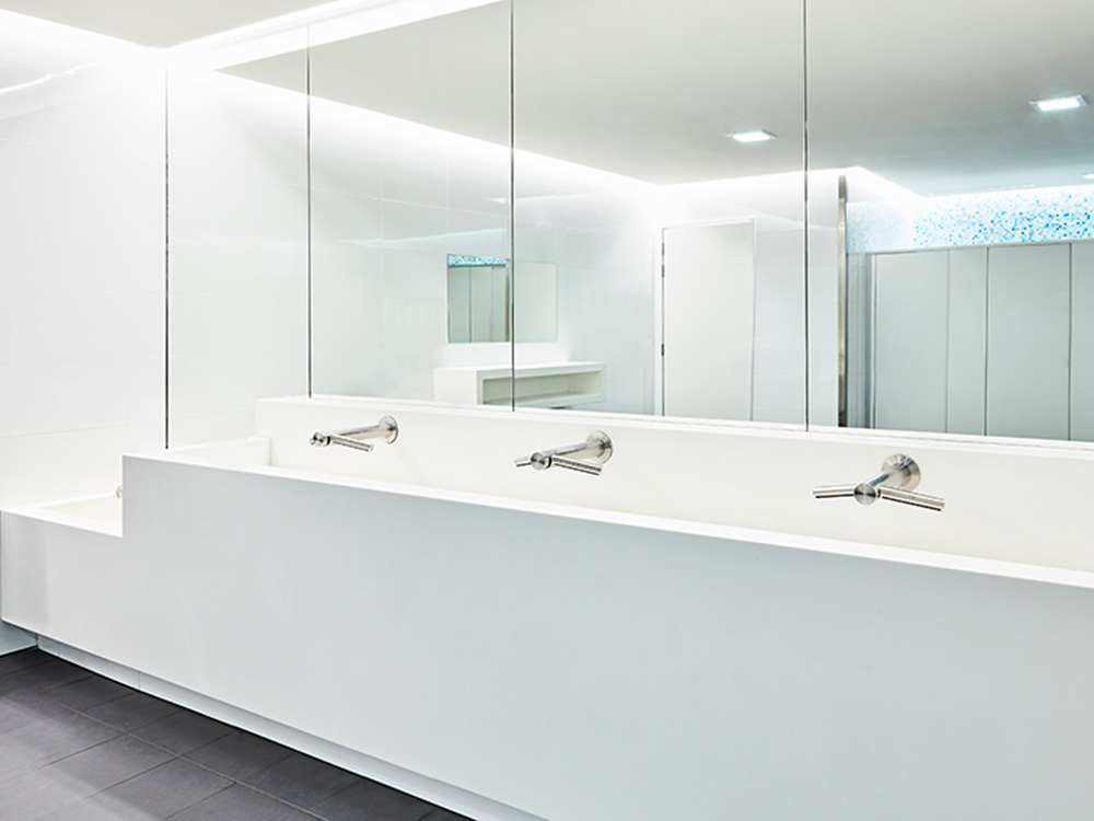 Interior view of public washroom featuring Dyson taps and hand dryers