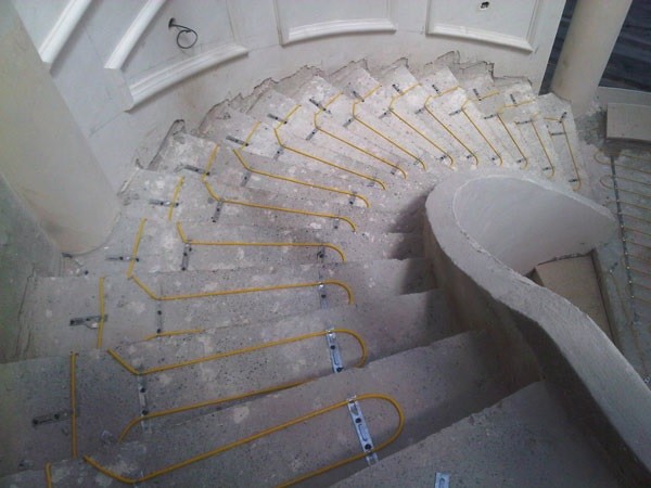 In-screed heating cables installed on a stairway
