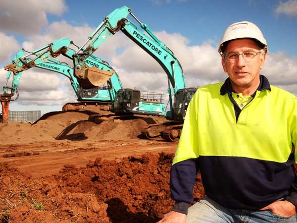 Micheal Bevilacqua with three of his Kobelco machines on a housing development site in Truganina in Melbourne’s outer western suburbs