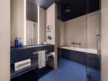 Corian® was used for the bathroom vanity, shelf under the vanity and bath front