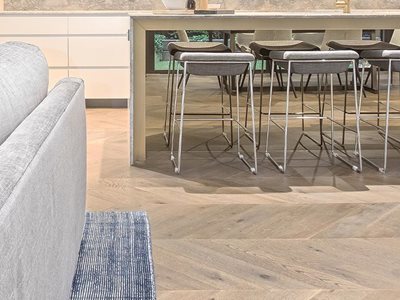 Plank Floors Chevron parquetry flooring in modern dining room interior