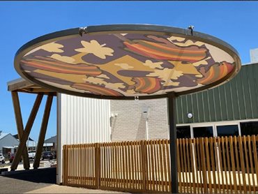 Each circular shade structure features a different colourful design adapted from Steven Carson's artwork 