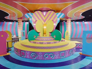 The designers used geometric forms, gender-stereotyped colours and symbolic imagery to create vibrant, theatrical scenography (Photo: Sean Fennessy)