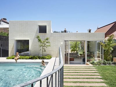 residential swimming pool back yard cream stacked bricks