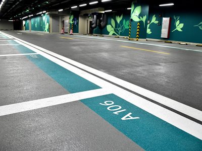 Detail of underground car park with numbered sections and floral wall design