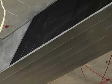 A structural strengthening solution using Carbodur laminates was used to effectively line a loadbearing beam to protect against the new shear loads 