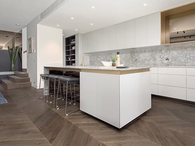 Plank Floors Chevron parquetry flooring in modern residential kitchen interior