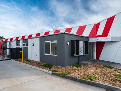 External building facade of pre-finished compressed fibre cement panel