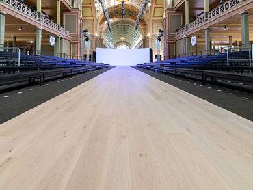 The Corsica Oak runway is paired with a sleek black solution dyed nylon cut pile twist carpet, Timeless in colour 795 Black Magic