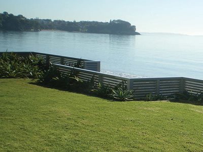 Outdoor View of Louvre Boundary Wall Between Backyard and Water