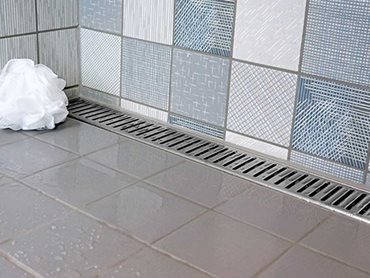 The Vision shower channel can be installed against one wall so that the floor is only required to slope in one direction