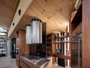 The kitchen is supported by a highly architecturally refined roof truss with a top chord of composite CLT and steel