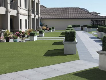 Low maintenance Outdure tiles (Mineral), UltraPlush synthetic turf and EcoDecking decking boards were installed,
