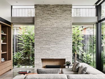 In the rear family room, the fireplace design is recreated with a 3.8m chimney of Kolumba bricks