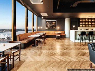Pallido herringbone timber flooring provides seamless transitions between materials of carpet and stone