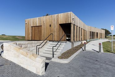 The existing building was too practical to knock down so SCA upgraded its amenities, gave it a new veranda and access route, and wrapped it in a skin of hardwood battens.  Photography by Brett Boardman