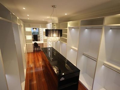 Walk in wardrobe with custom furniture