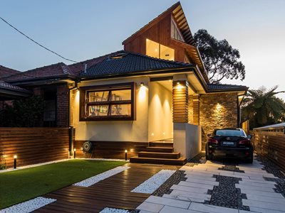 Night time image of house exterior with terracotta tiles 