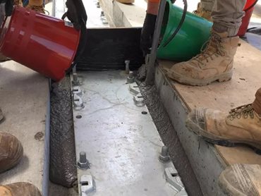 The grouting was done under the base plate of the crane rails 