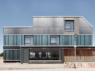 The prototype recyclable house features recycled sauna benches, old industrial cast glass panels and Equitone fibre cement panels