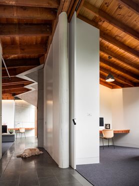Chamfer features on ceiling. Cavity slider creates a flexible living space. Photography by Andrew Latreille