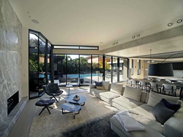 A series of windows act as picture frames, capturing views towards the pool and patio