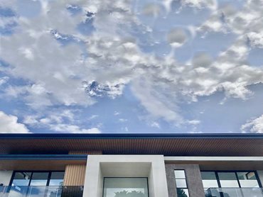 Alumate woodgrain aluminium in a Mahogany finish enhances the aesthetic impact of the building 
