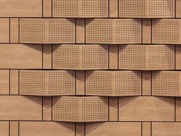 The custom perforated saw-tooth panels offer an absorptive and diffuse surface 
