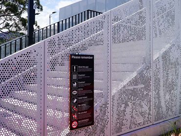 The new perforated metal footbridge, staircase, and landing screens feature a complex tree design