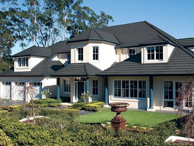 Exterior view of multi-storey home with concrete roof tiles 