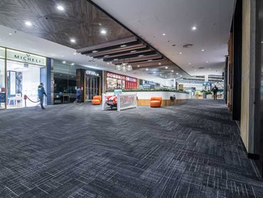The carpet planks were installed in a herringbone pattern below an ornamental central ceiling panel of timber parquetry