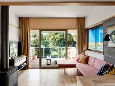 The living space on the upper floor captures generous amounts of light, air and views