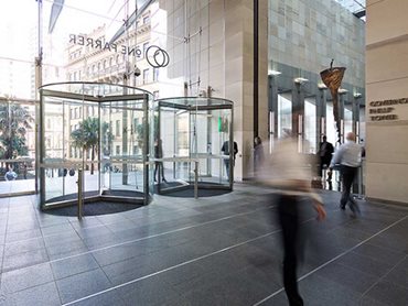The revolving doors were designed with extended glass roofs with a square front face to align with the frameless glass above