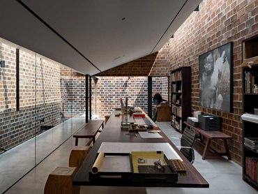The workspaces are surrounded by brick walls to minimise distraction
