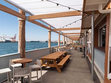 The refurbished dockside cargo shed takes full advantage of the building’s heritage features and waterfront aesthetic