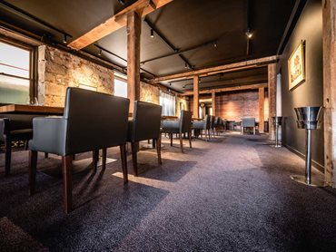 A custom woven floorcovering complements the warm sophisticated space of the Landscape restaurant and grill 