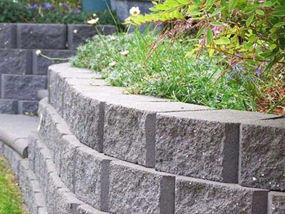 Grey retaining wall with garden beds