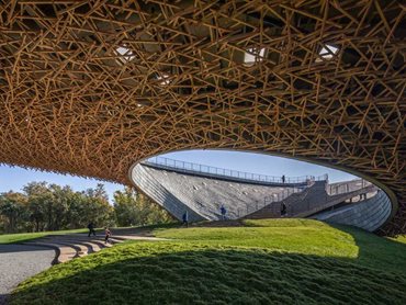 The powerful mountainous landscape informs the design of the wooden lattice roof