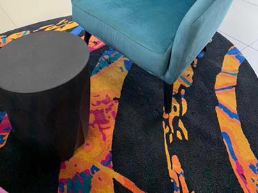 The hand tufted rug combines a bold use of colour with texture 