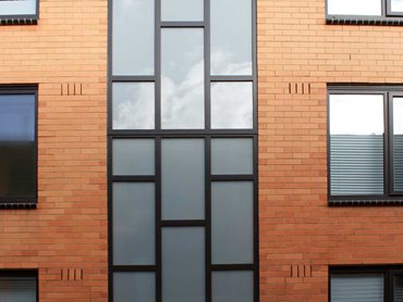 A darker external uPVC colour finish was used to modernise the look of the aging buildings 