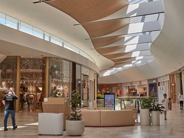 Bespoke feature timber and plasterboard ceilings throughout the shopping centre are reminiscent of rolling sand dunes