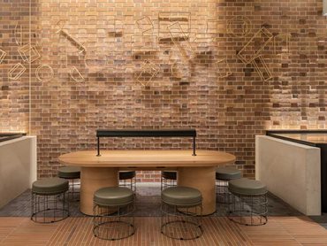 A space for meeting or relaxing in the new laneway, with Albicocca Arazzo bricks in the foreground. Image: David Chatfield
