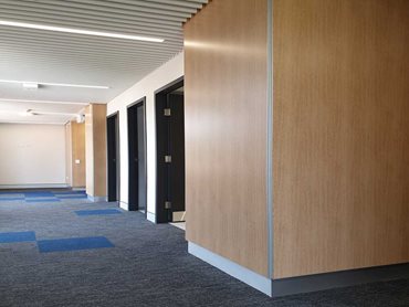 The walls adjacent to the lift doors are lined with durable SUPALINE panels finished in SUPAFINISH Tasmanian Oak laminate