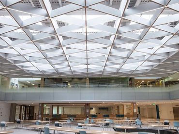 POLYLAM vertical baffle system features an ingenious arrangement of the baffles in a triangular design that imbues the ceiling with an open character