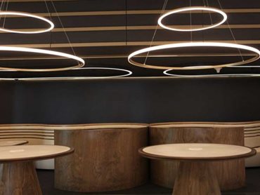 The tapered cylindrical bases of the tables in the upper foyer were wrapped using multiple slices of timber to give a smooth finish