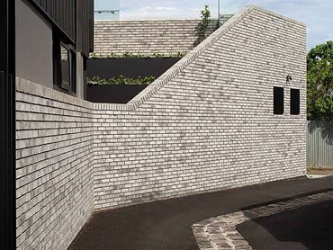 The brick is a light grey and it has beautiful textures to it