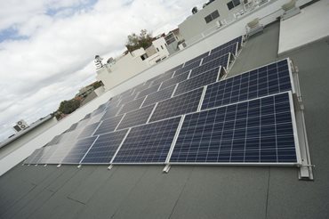 A roof-mounted solar photovoltaic system achieves a 13% reduction on operational carbon emissions